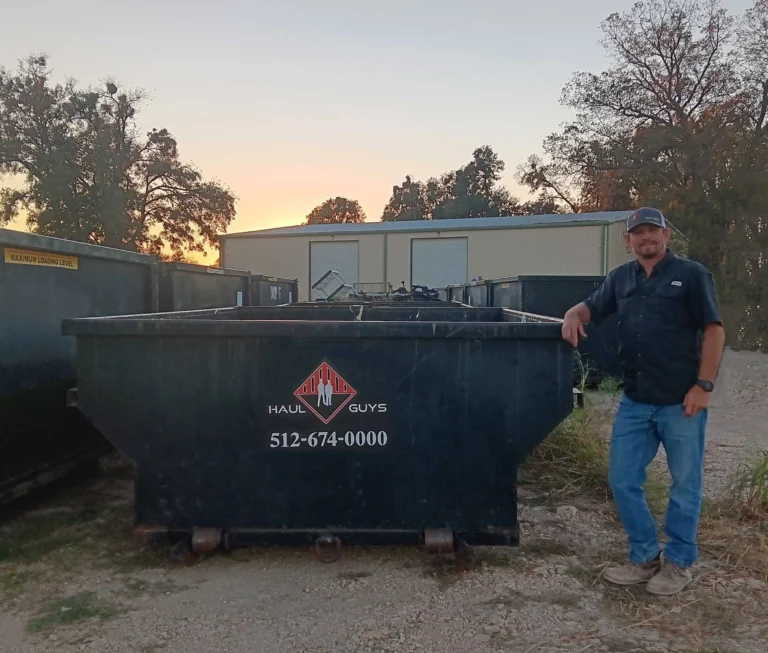 a man standing next to a dumpster