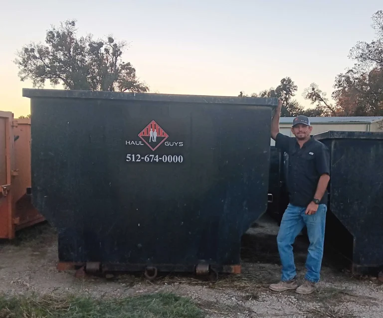 a man standing next to a dumpster