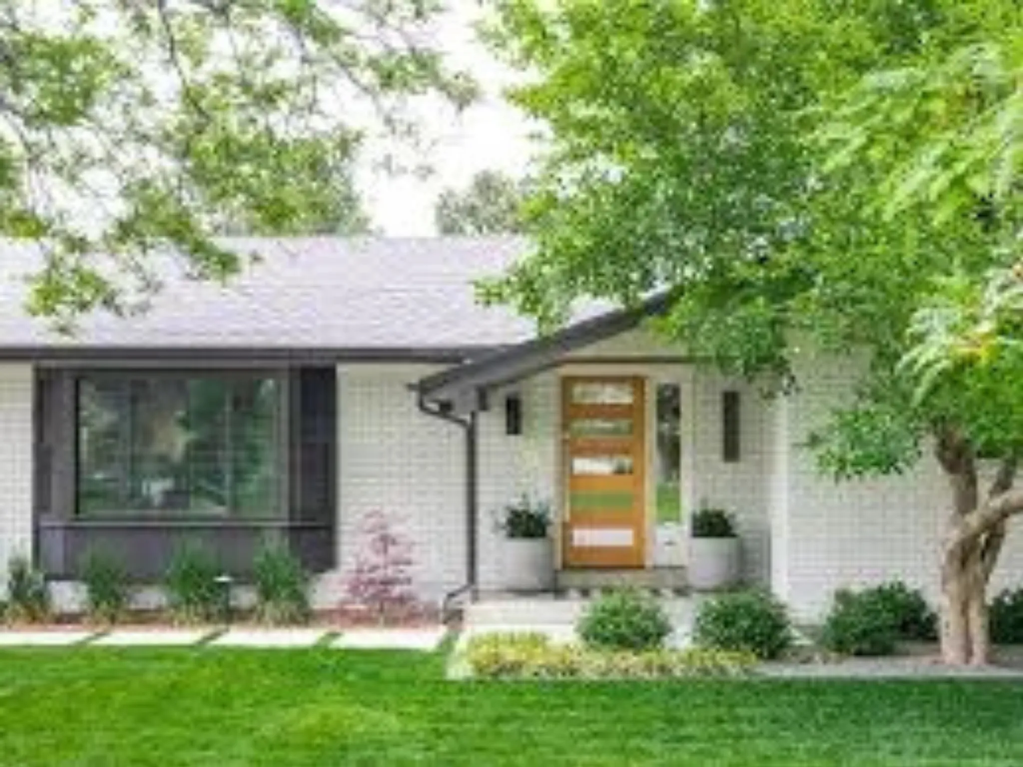 a house with a lawn and trees